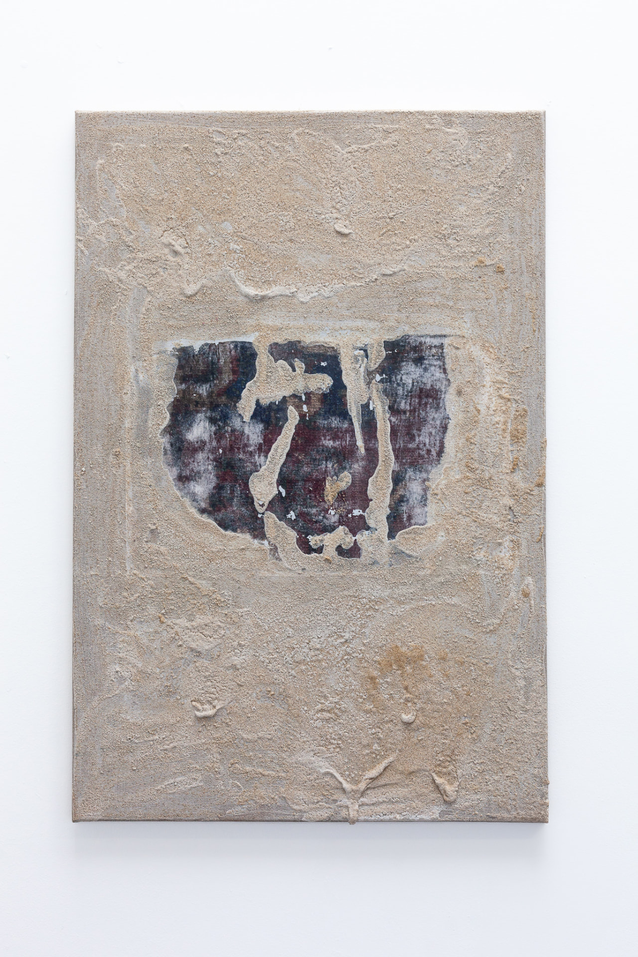 Textured canvas with a dark organic void surrounded by sand and plaster