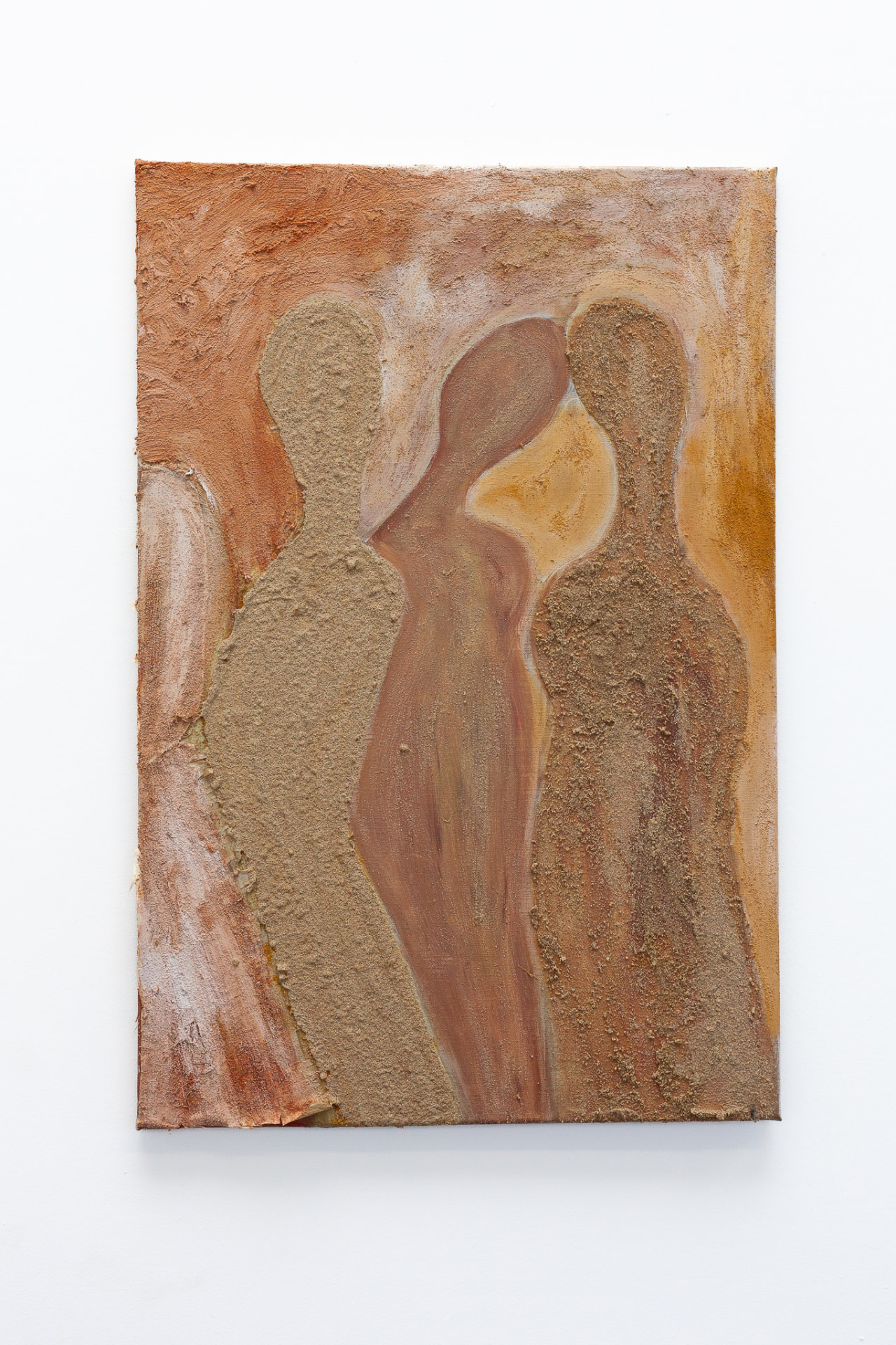Collage on canvas of three abstract standing figures in warm earth tones