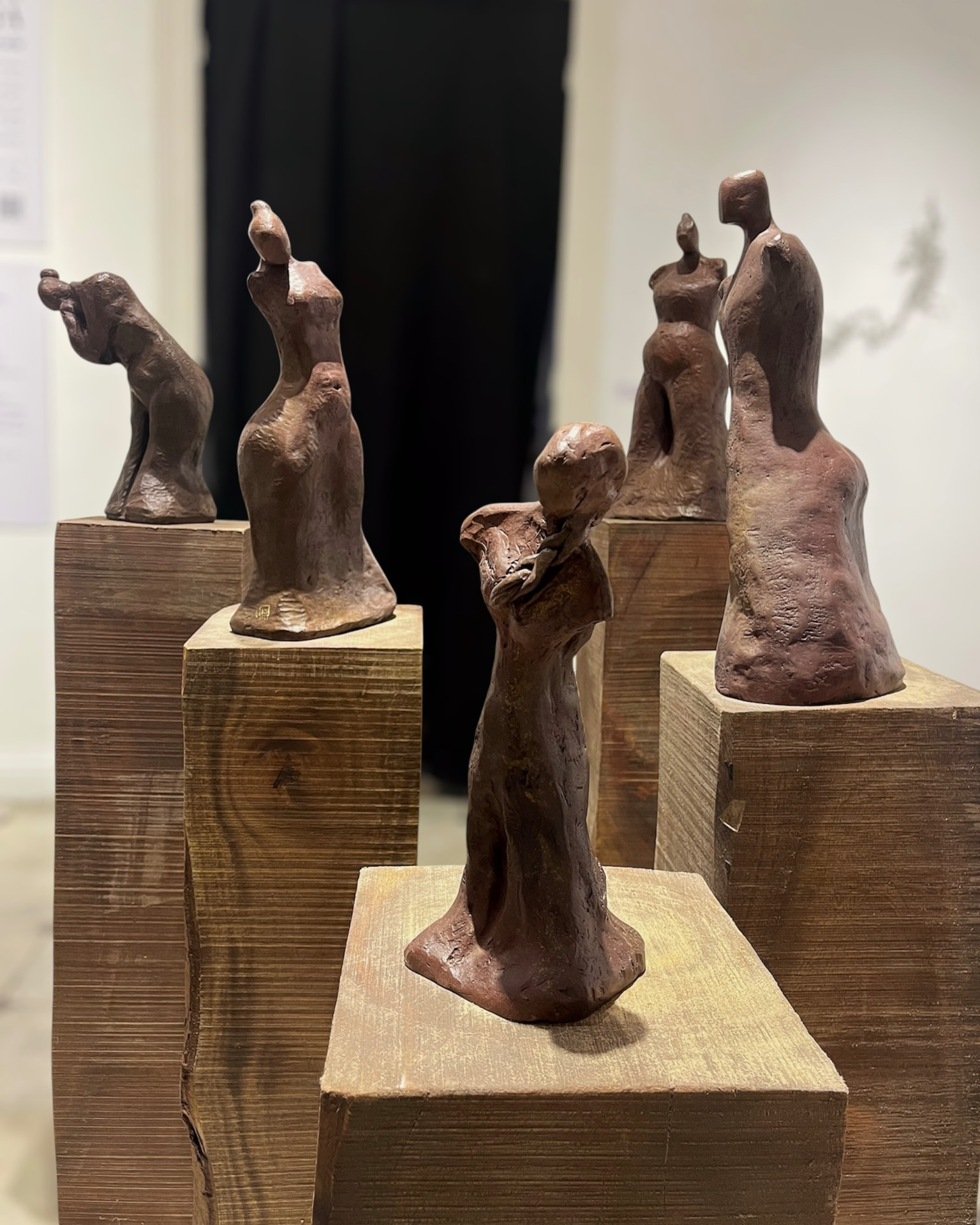 Cluster of small bronze figure studies on wooden plinths