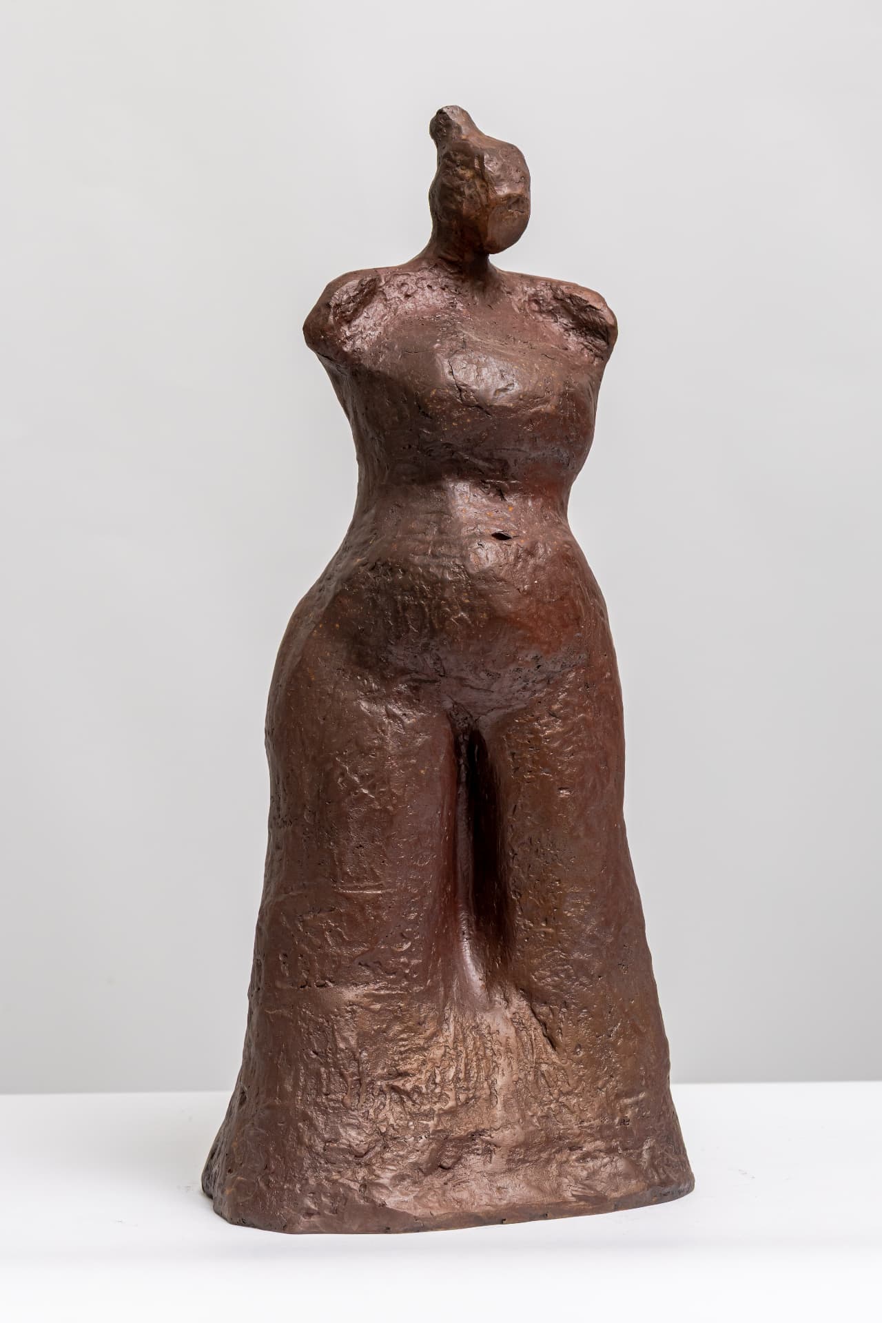 Aset with Child, standing bronze torso with hair in a bun