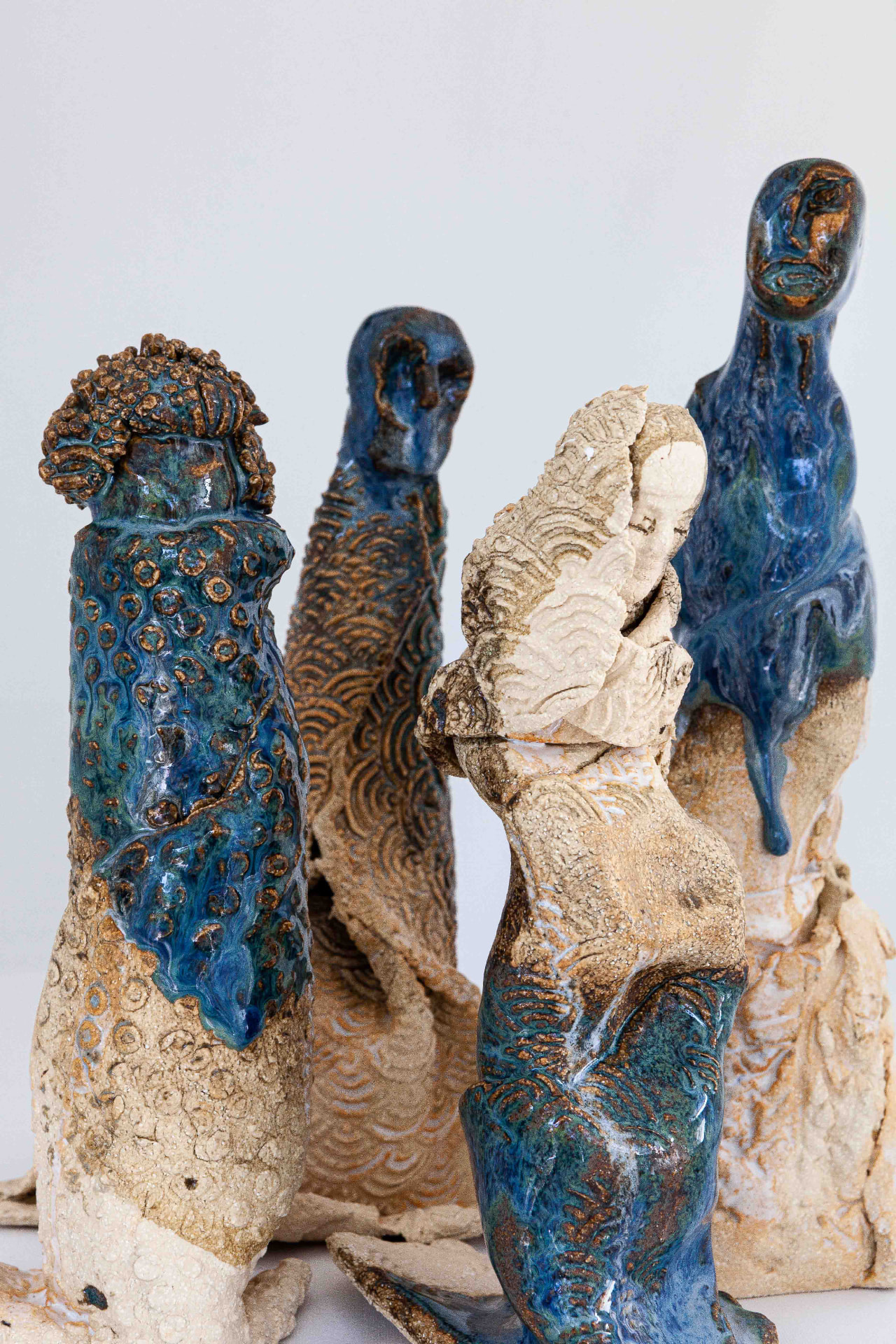 Group of blue-glazed and sand-coloured ceramic figures